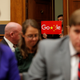 A demonstrator holds up a sign in the doorway as Google CEO Sundar Pichai testifies at a House Judiciary Committee on greater transparency in Washington, U.S., December 11, 2018. REUTERS/Jim Young - RC19CFD97160